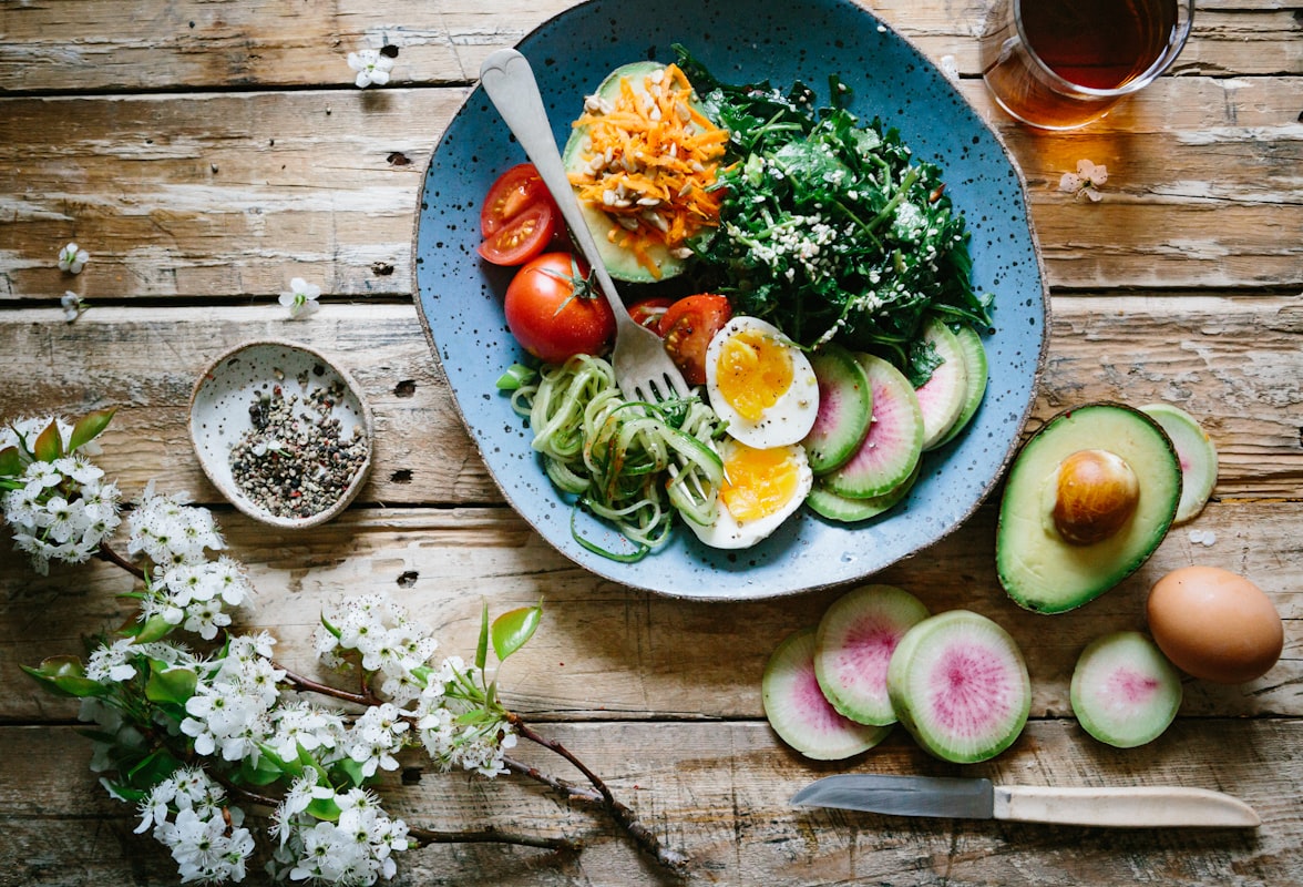 Fresh vegetable soup with herbs in white bowl